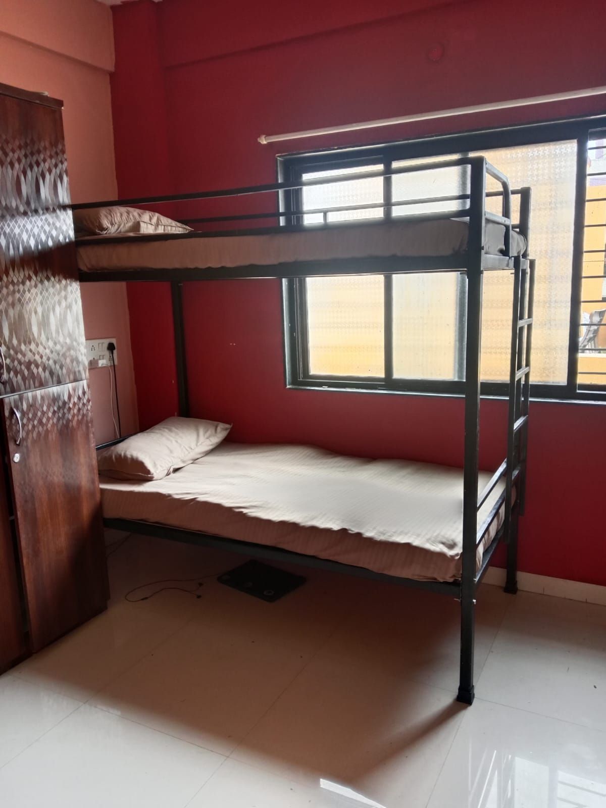 Comfortable upper bunk bed in a shared PG room